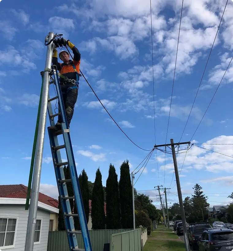Level 2 electrician working on service cable connection